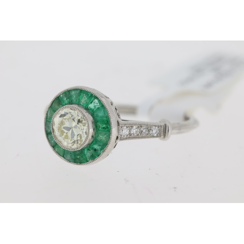 1037 - Platinum round old cut centre diamond approx 0.60ct  with green emerald cluster and diamond set shou... 