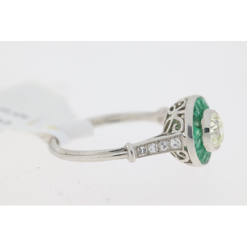 1037 - Platinum round old cut centre diamond approx 0.60ct  with green emerald cluster and diamond set shou... 