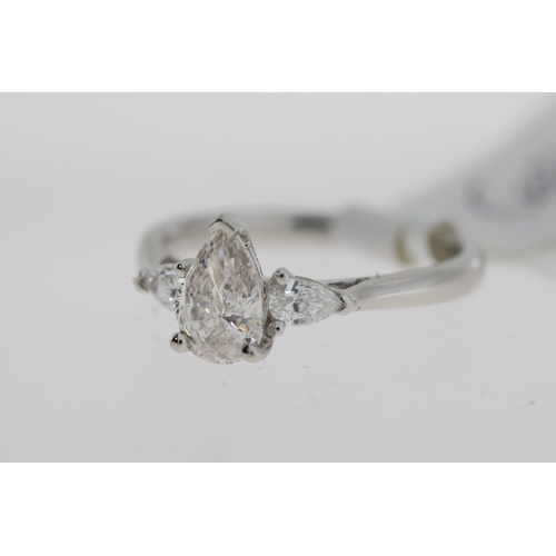 1039 - Platinum Pear cut three stone ring. Very light Pink pear cut Diamond centre 0.72ct with internally F... 