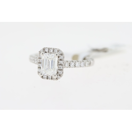 1046 - 1.01ct GIA F colour Emerald cut diamond ring with diamond set halo and shoulders. Emerald cut diamon... 