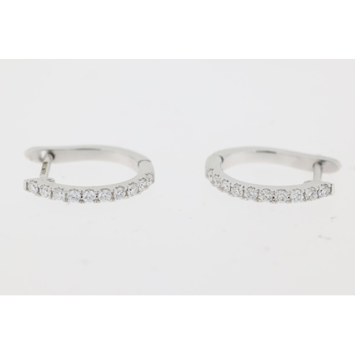 1054 - 18ct white gold brilliant cut diamond claw set hoop earrings. Approximate total diamond weight 0.20c... 