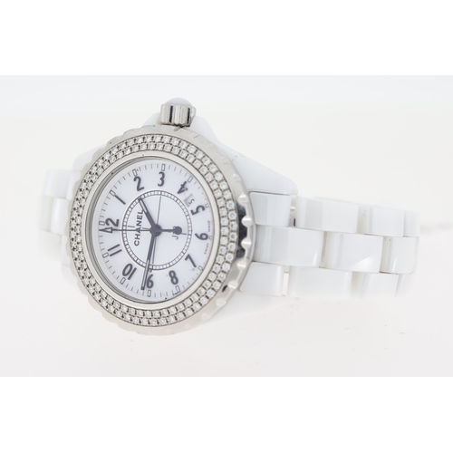 23 - LADIES CHANEL J12 WHITE CERAMIC DIAMOND BEZEL BOX AND PAPERS 2009, circular white dial with arabic n... 