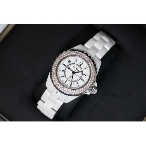 23 - LADIES CHANEL J12 WHITE CERAMIC DIAMOND BEZEL BOX AND PAPERS 2009, circular white dial with arabic n... 