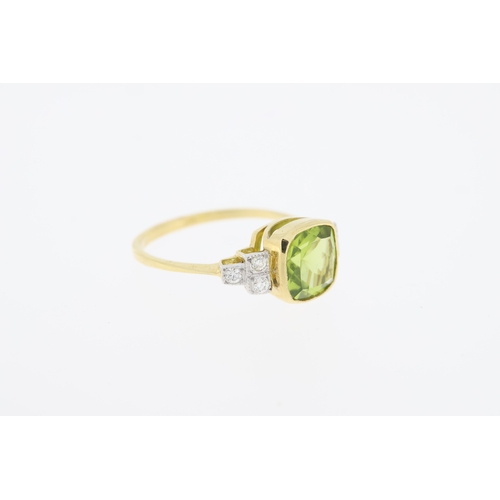 1006 - Stamped 18ct, yellow gold, rub over set peridot and diamond ring. (Peridot 2.10 carats, diamonds tot... 