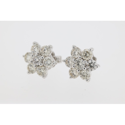 1010 - 18ct White gold cluster earrings each comprising 7 diamonds, totalling 2.0 carats.