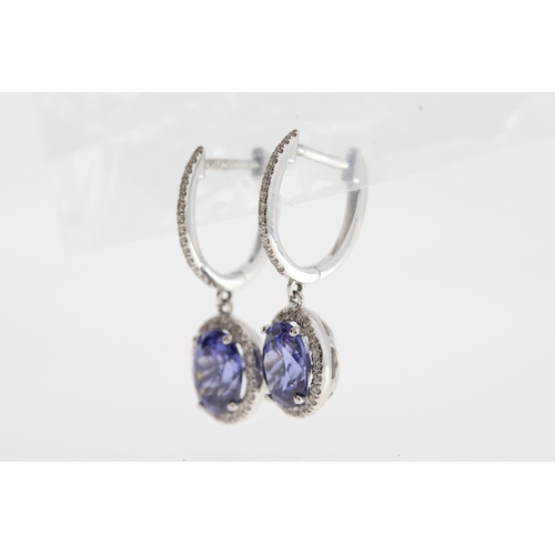 1002 - A pair of 18ct white gold tanzanite drop earrings.