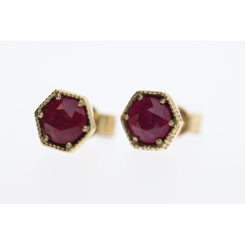 1006 - A pair of 9ct ruby stud earrings