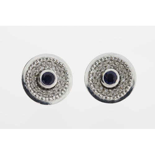 1010 - A pair of 18ct sapphire & diamond stud earrings.