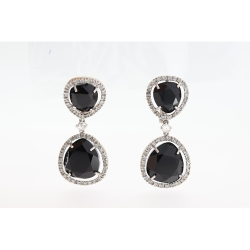 1011 - A pair of 18ct blue stone & diamond drop earrings.