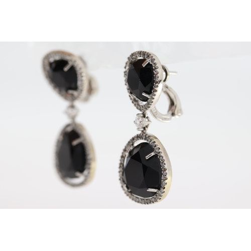 1011 - A pair of 18ct blue stone & diamond drop earrings.