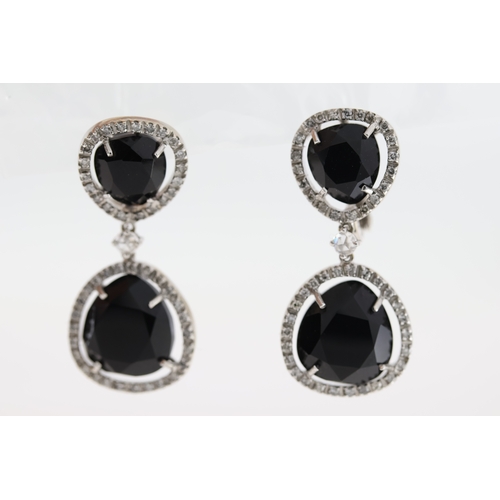 1011 - A pair of 18ct blue stone & diamond drop earrings.