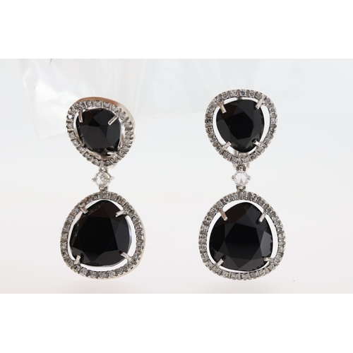 1011 - A pair of 18ct blue stone & diamond drop earrings.