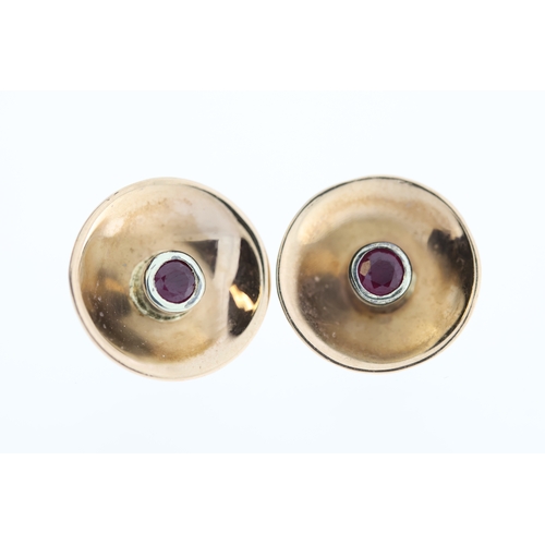 1012 - A pair of 9ct ruby studs.