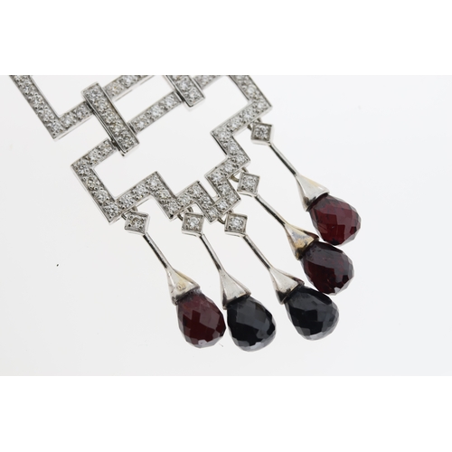 1017 - An 18ct diamond & garnet geometric necklace.