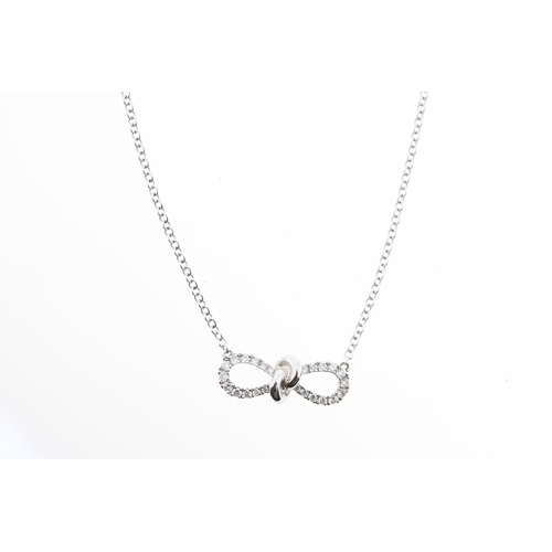 1020 - An 18ct diamond bow necklace.