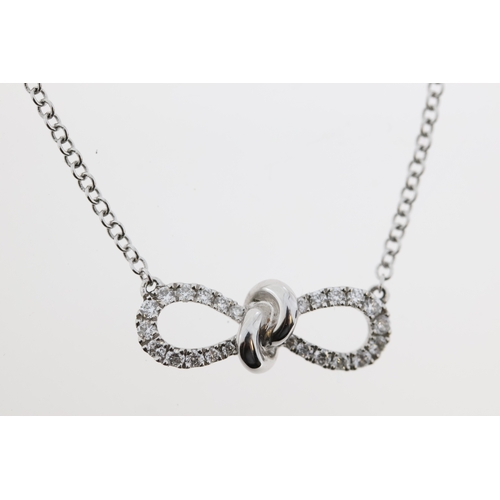 1020 - An 18ct diamond bow necklace.