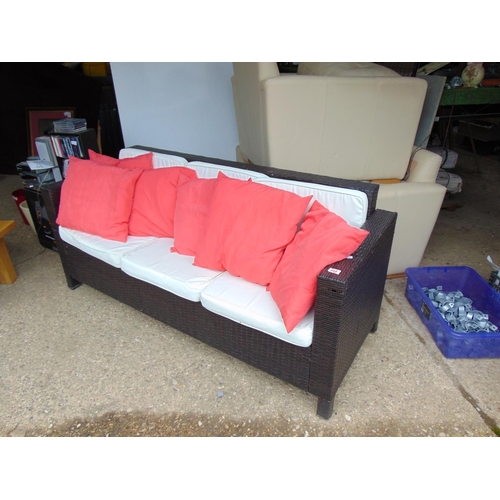 668 - Rattan garden sofa with cushions