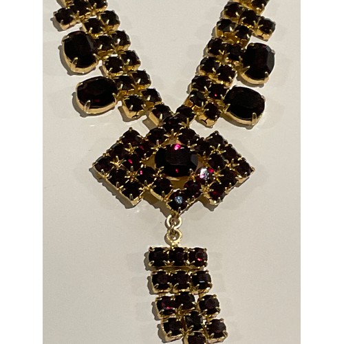 85 - gold coloured dress necklace with red stones Art Deco style