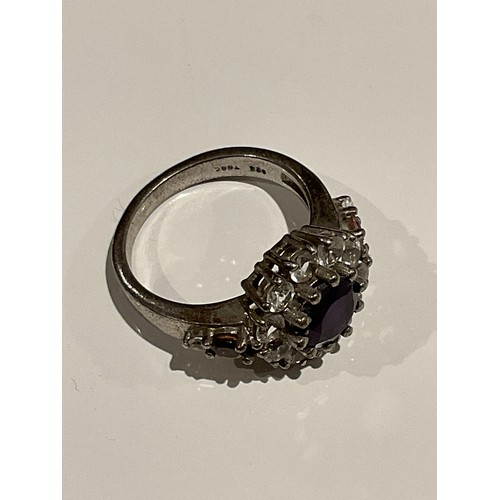 111 - silver stamped 925 ring with purple centre stone surrounded with clear stones 5.4 grams... 