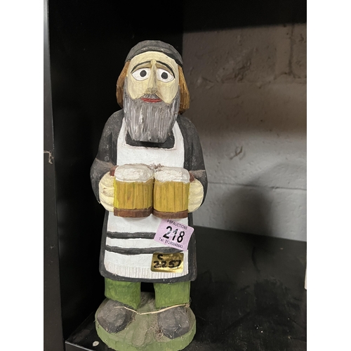 218 - carved figure holding beer