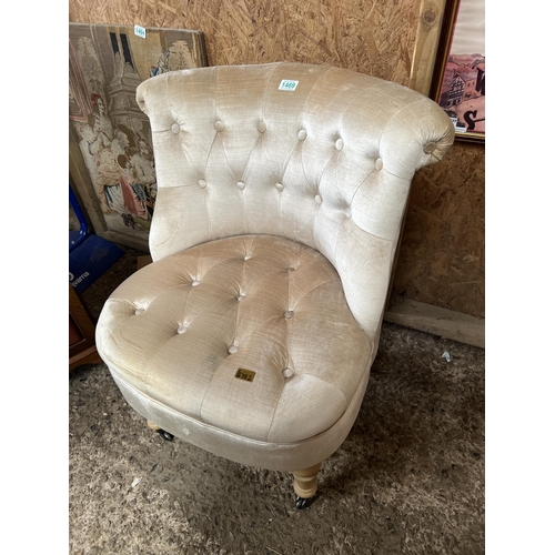 1469 - upholstered Champagne colour chair on casters