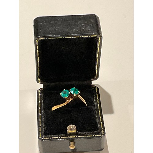 15 - 18ct gold ring with 2 x deep royal green colour stones brilliant cut with cross over yellow gold mou... 