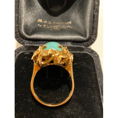 24 - 18ct gold & turquoise polished stone , with a leaf design mount around the large centre stone , ... 