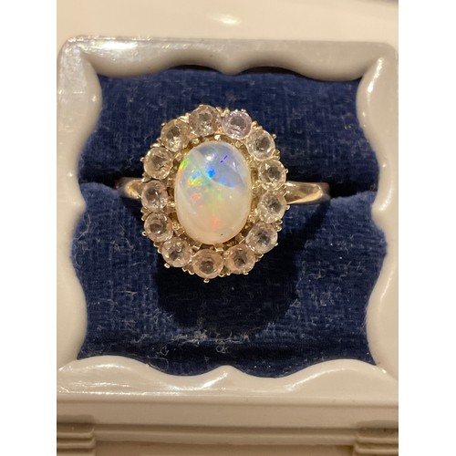 28 - Opal 9ct gold cluster ring , oval opal centre surrounded by 13 cz stones , yellow gold , stamped 9ct... 