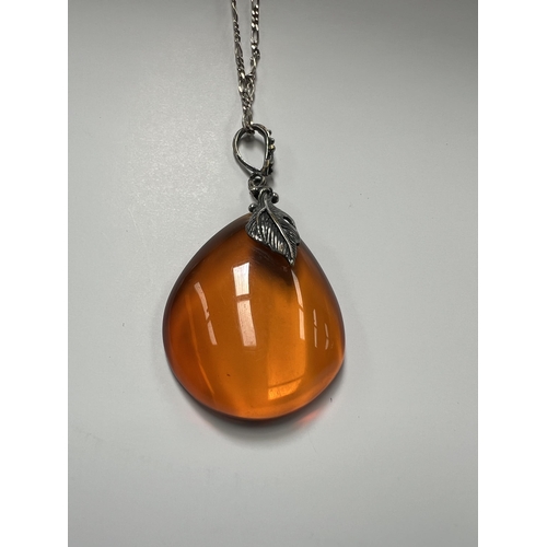 37 - Silver necklace with large amber pendant 18” chain , 8.9 grams