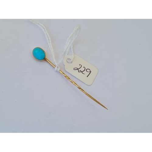 229 - An unusual turquoise and gold stick pin opening to concealed locket