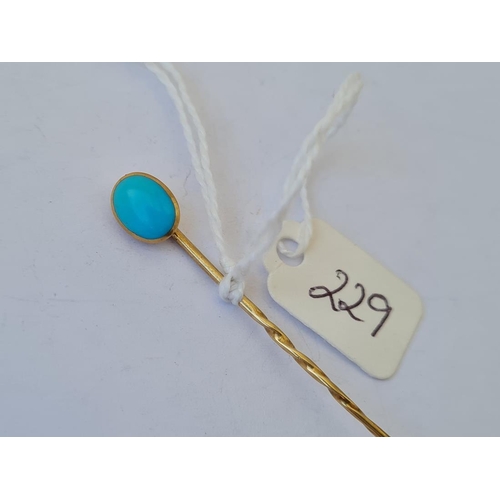 229 - An unusual turquoise and gold stick pin opening to concealed locket