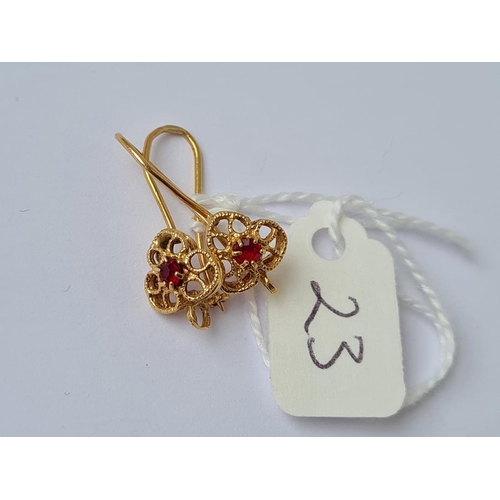 23 - A pair of fancy filigree red stone set earrings