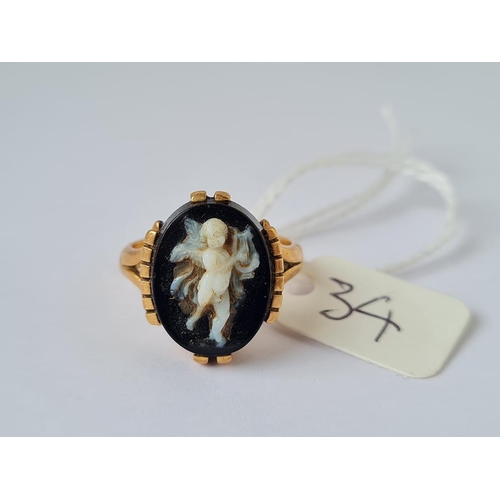 34 - A gold and hardstone cherub ring size L 6.6g inc
