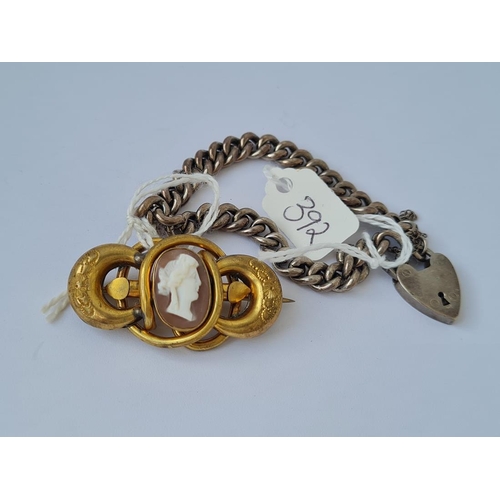 392 - A silver curb bracelet and a gilt cameo brooch