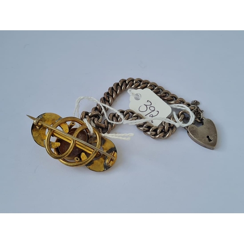 392 - A silver curb bracelet and a gilt cameo brooch