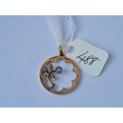 488 - A circular floral stone set gold pendant