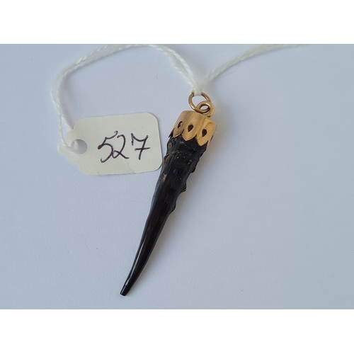 527 - A horn pendant with 9ct gold mount