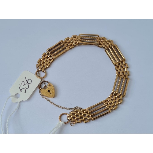 536 - A 4 bar gate bracelet with scroll engraved padlock clasp in 9ct 8g