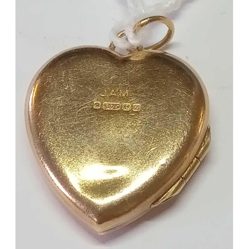 210 - A heart engraved locket in 9ct
