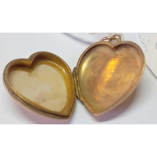 210 - A heart engraved locket in 9ct