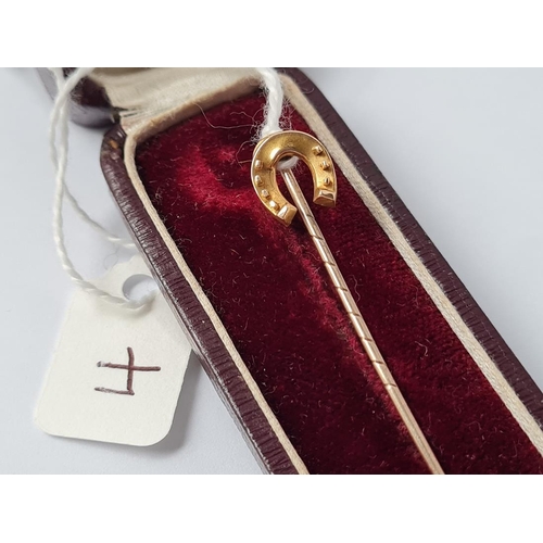 4 - A boxed horse shoe stick pin in 15ct gold