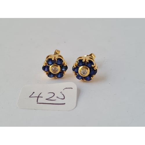425 - A pair of diamond & sapphire cluster earrings set in gold