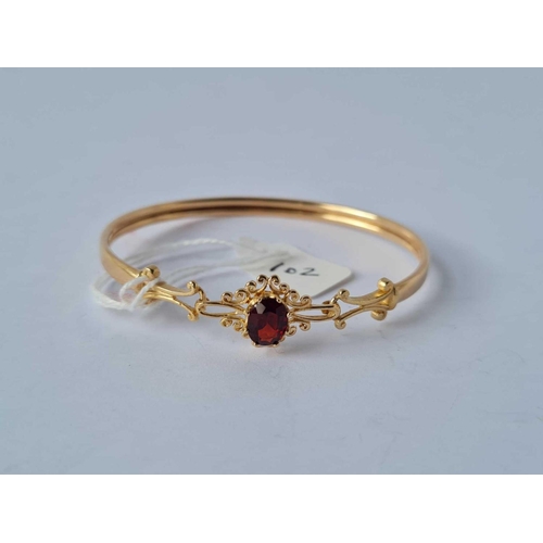 102 - A garnet bangle 9ct - 6.1 gms