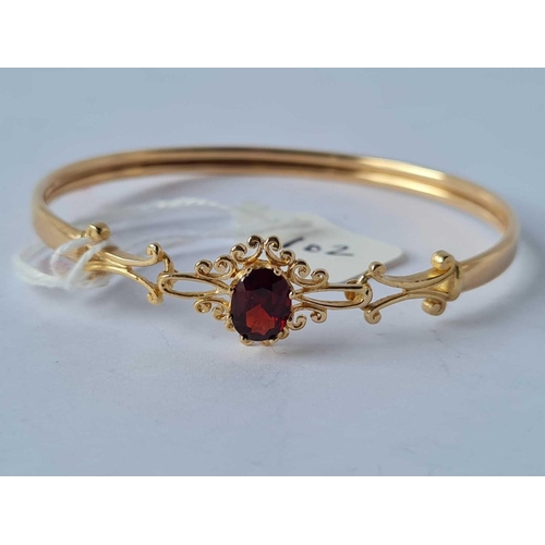 102 - A garnet bangle 9ct - 6.1 gms