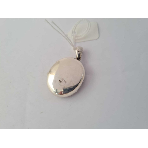 111 - A antique Victorian hallmarked locket with scrolled decoration to front