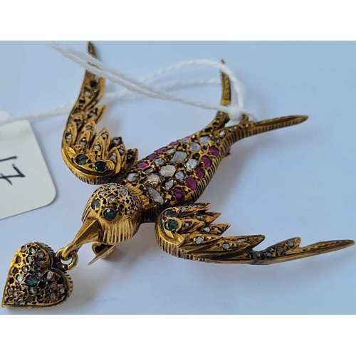 17 - AN EARLY GEM ENCRUSTED FLYING BIRD BROOCH HOLDING A GEM ENCRUSTED HEART TO BEAK SET IN GOLD THE STON... 