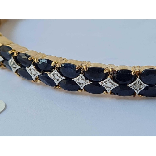 18 - A good silver gilt bangle set with two rows of black sapphires and diamonds