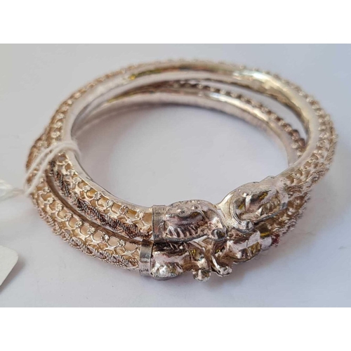 71 - Two silver Oriental fretwork dragon bangles