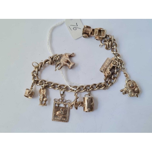 76 - Silver charm bracelet set with 9  charms  48.1g