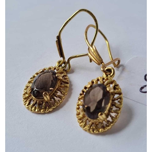 82 - A pair of 9ct smoky quartz drop earrings